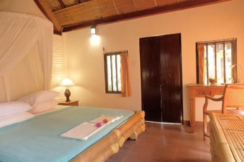 a bedroom with a bed with a towel on it at Sua Bali in Ubud
