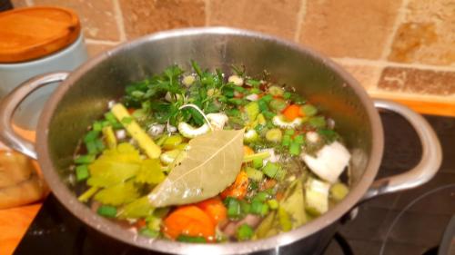 a pot filled with vegetables on a stove at La Parenthèse, chambres d'hôtes in Rochegude-Drome