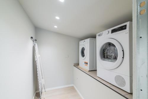 a laundry room with a washer and dryer on a shelf at Pavia Tower - by Host4U in Pavia