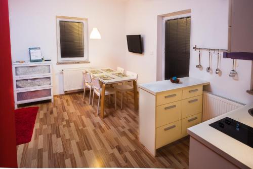 a kitchen with a table and a dining room at Apartments Lavric in Nova Vas