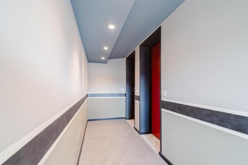 a hallway with white walls and a blue ceiling at Pavia Tower - by Host4U in Pavia