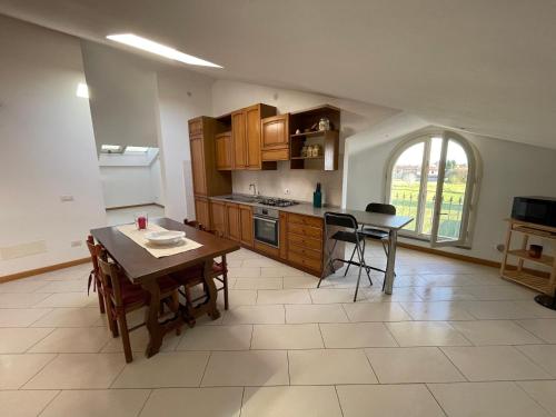 a kitchen with a table and a dining room at Charming apartment in Tuscany in San Piero in Campo