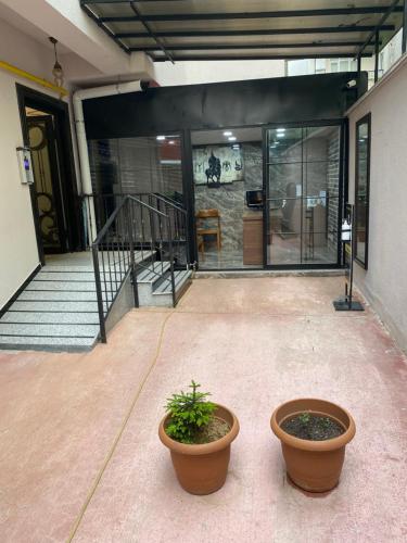 two potted plants sitting in front of a building at BALEK APART in Pelitli