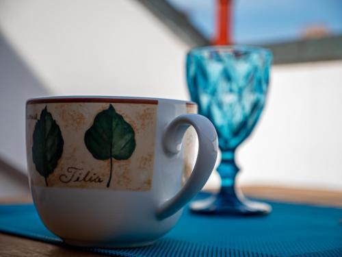 a coffee cup and a wine glass on a table at Mansarda Le Torri in Mantova