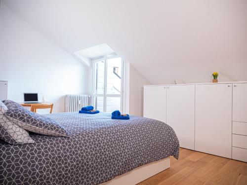a white bedroom with a bed and a white cabinet at Mansarda Le Torri in Mantova