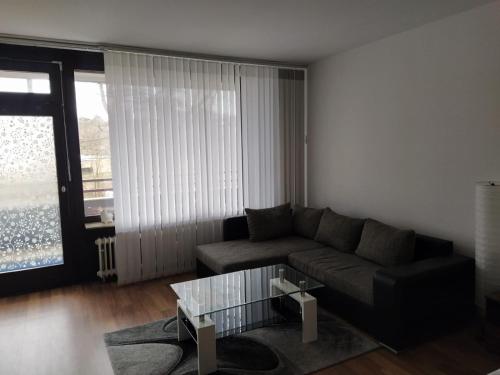 a living room with a couch and a glass coffee table at App B210 gemütlich und ruhig in Lahnstein