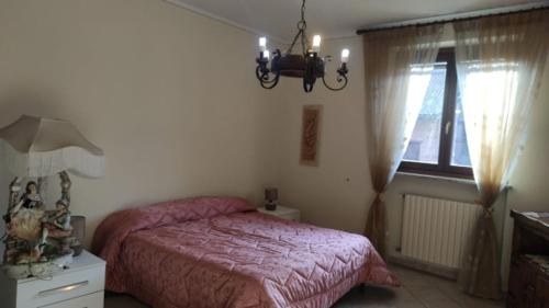 a bedroom with a pink bed and a window at Casa Mami LUXURY big Holiday Hause in Sommariva del Bosco