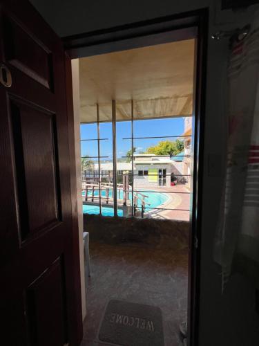 a door view of a swimming pool from a house at GingGing Hotel And Resort in Oslob