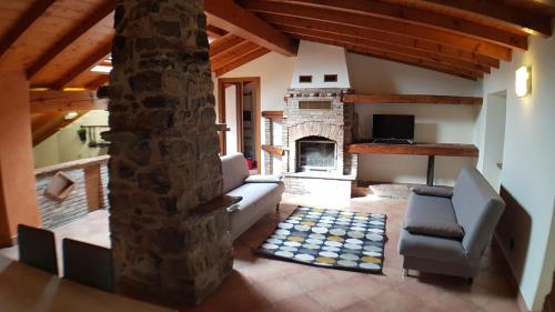 a living room with a couch and a fireplace at CASA VAL DEL RISO in Gorno