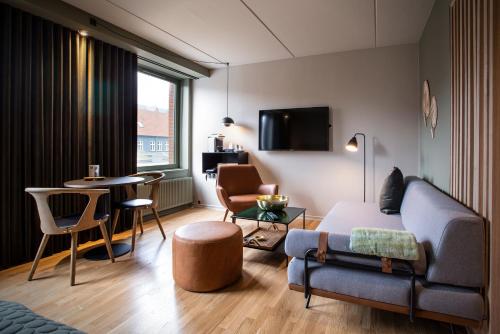 a living room with a couch and a table at Hotel Britannia in Esbjerg