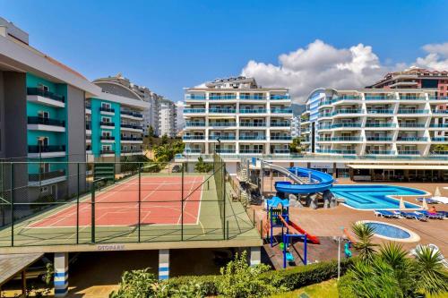 a tennis court in a city with buildings at SA Apartments! Crystal Family Suites in Alanya