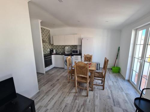 a kitchen and dining room with a table and chairs at Casa 50 in Lagos