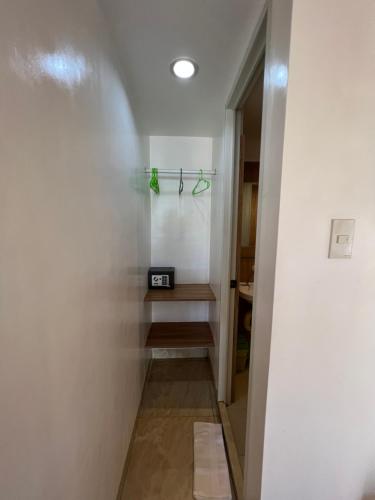 a bathroom with a walk in shower next to a wall at GingGing Hotel And Resort in Oslob