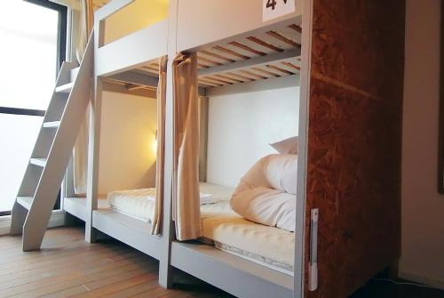 Ce lit superposé se trouve dans un dortoir doté de lits superposés. dans l'établissement Ten to Sen Guesthouse, à Takamatsu