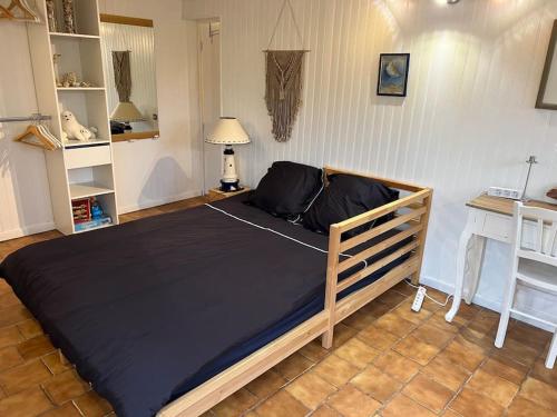 a bedroom with a large bed in a room at Maison indépendante avec 6 chambres proche du tram A in Lormont