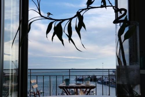 a view of the ocean from a window with a table at CASA D'AMARE in Salerno