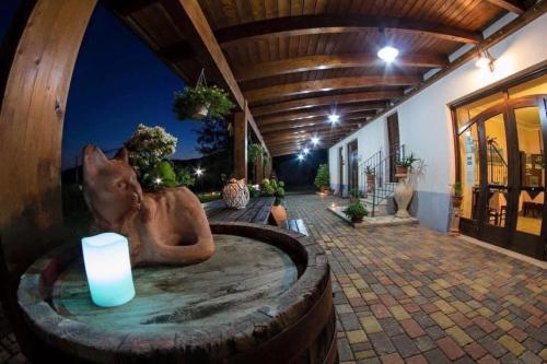 a statue of a cat in a bath tub with a candle at Agriturismo La Fattoria in Norcia