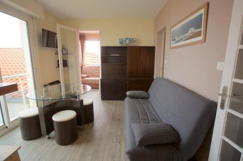 uma sala de estar com um sofá e uma mesa de vidro em Hossegor - Plage 100m - Surf - Famille - Couple em Soorts-Hossegor