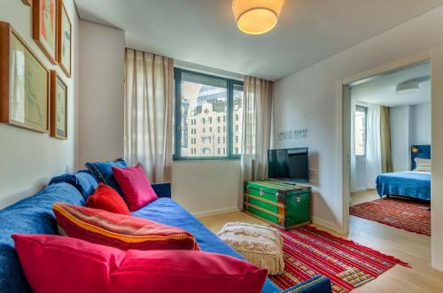 a living room with a blue couch and a television at LSA Liberdade by Numa in Lisbon