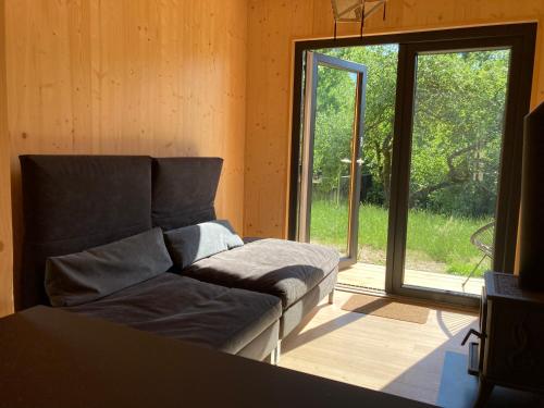 a living room with a couch and a sliding glass door at Shambhala centrum in Lúčka