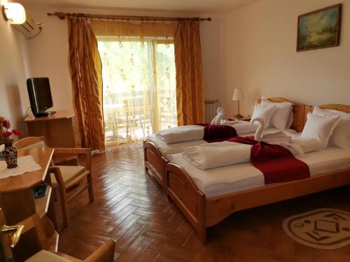 1 dormitorio con 2 camas, mesa y ventana en Hotel Wels, en Beştepe
