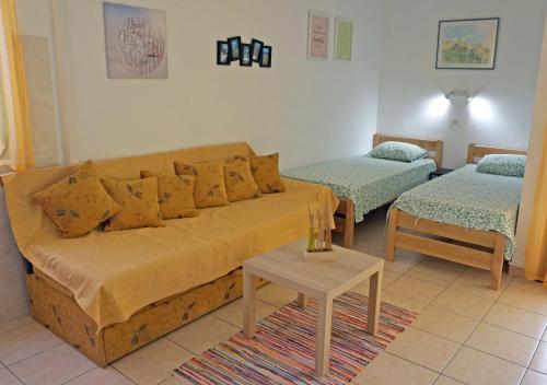 a living room with a couch and two beds at Studio Apartment Michelle - Intermezzo with sea view in Rabac