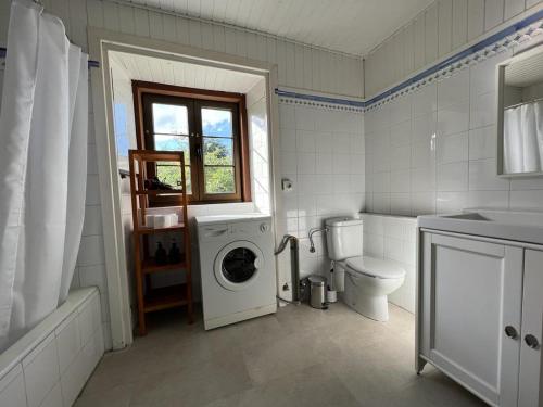 uma casa de banho com uma máquina de lavar roupa e um WC em Apartamentos Les Casines De San Martin con Aparcamiento y Wifi Incluido em San Martin de Bada