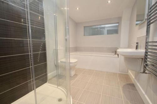 a bathroom with a shower and a toilet and a sink at 3 bedroom barn conversion in the country (Pet Friendly) in Stawell