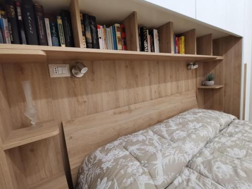 a bedroom with a bed and book shelves at Casa Marinella in Crotone