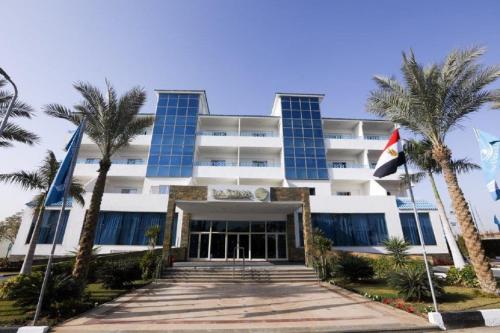 a building with palm trees in front of it at The Guard Hotel in Cairo