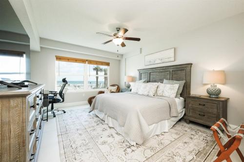 a bedroom with a bed and a desk and a kitchen at Unit 102 Aruba - 3 Bedroom Ocean Front in Daytona Beach