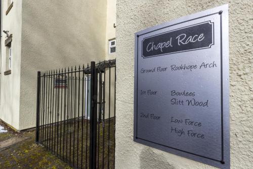 a sign on the side of a building with a gate at H C Property - Chapel Race Countryside Retreat in Saint Johns Chapel