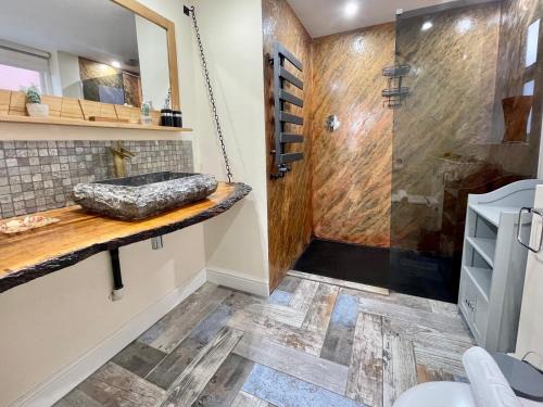 a bathroom with a shower and a sink at The Bungalow 1A Wenlock in York
