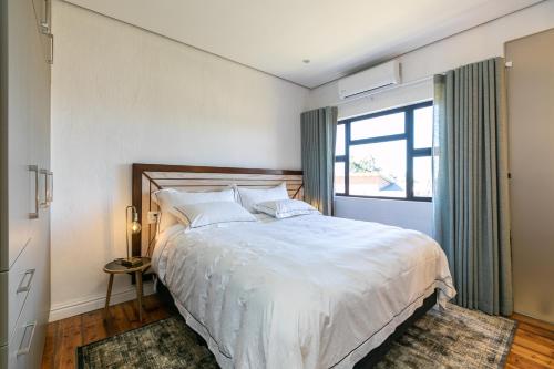 Un dormitorio con una cama grande y una ventana en Bali and Eva Midlands, en Nottingham Road