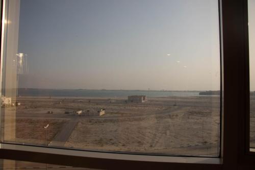 a view of a desert from a window at Durrat Manzli ApartHotel in Al Khobar