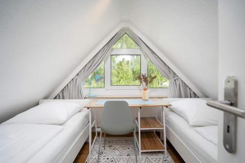 a dining room with a table and a window at FeWo Baltic Pelzerhaken in Pelzerhaken