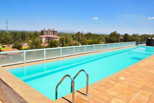 a large swimming pool on the roof of a building at One bedroom fully furnished apartment in Kiambu