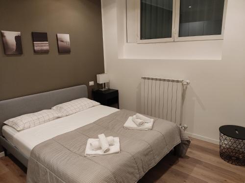 a bedroom with a bed with two towels on it at Fiera City Life 2 Top Apartment in Milan