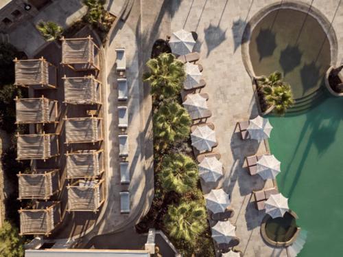 an overhead view of a building with trees and water at Seaside A Lifestyle Resort - Adults Only in Agia Pelagia