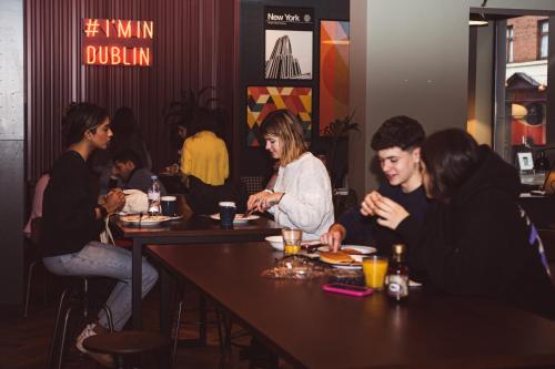 a group of people sitting at a table in a restaurant at Latroupe Jacobs Inn in Dublin