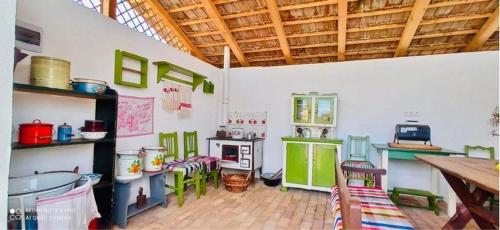 a large room with a kitchen with green appliances at Mátrai pincés udvar in Mátramindszent