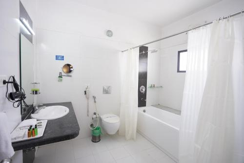 a bathroom with a sink and a toilet and a shower at HOTEL AVN GRAND in Rānchī
