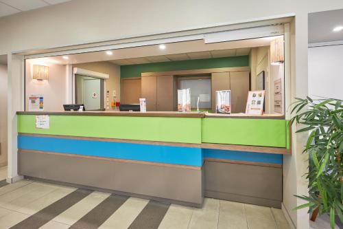 a lobby of a hospital with a reception counter at Pierre & Vacances Résidence Le Chant des Oiseaux in Courseulles-sur-Mer