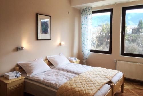 a bedroom with a bed and a large window at Hotel Hinovi Hvoyna in Hvoyna