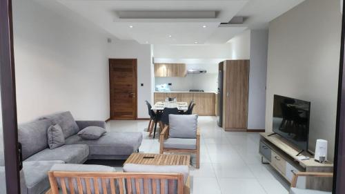 a living room with a couch and a table at SEAVIEW LUXURY APPARTMENT in Flic-en-Flac