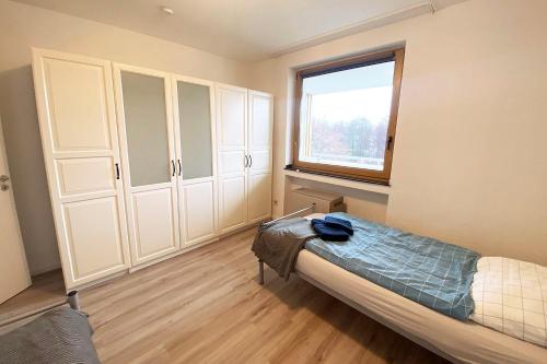 a bedroom with a bed and a window at 2-room apartment with balcony in Meckenheim