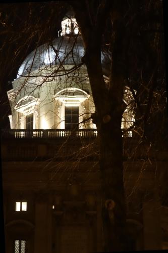 a white building with a domed roof at night at Princeps Boutique Hotel in Rome