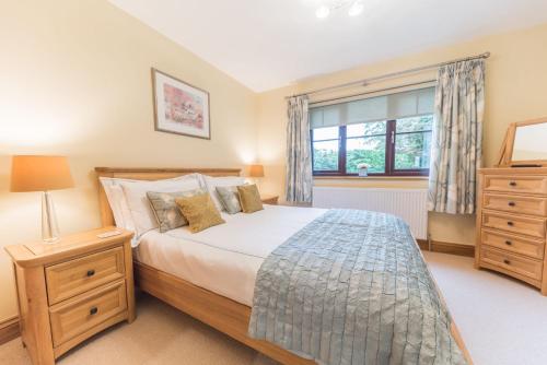 a bedroom with a large bed and a window at Roseberry Cottage Coniston in Coniston