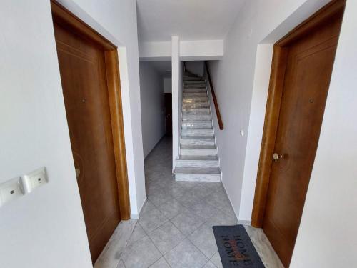 a hallway with stairs in a house at Δειλινά in Plati
