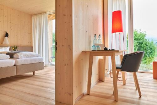 a bedroom with a desk and a bed and a chair at Kulturhof Stanggass in Bischofswiesen